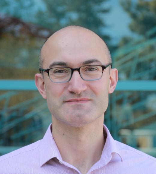 A professional headshot of Dr. Erkin Seker. 