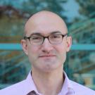 A professional headshot of Dr. Erkin Seker. 